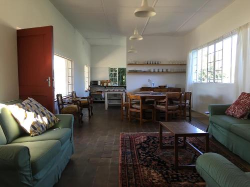 a living room with a couch and a table at The Old Mushroom Farm in Howick