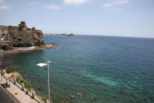 a view of a body of water with a flag at Casa Vitale in Aci Castello
