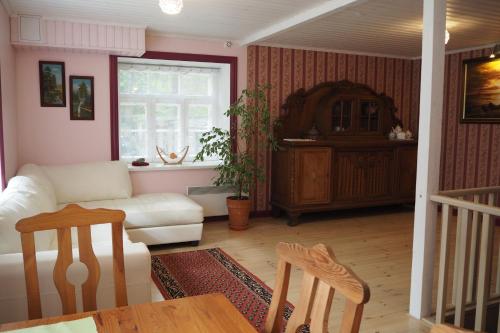 a living room with a white couch and a table at Lootuse Apartment in Tallinn