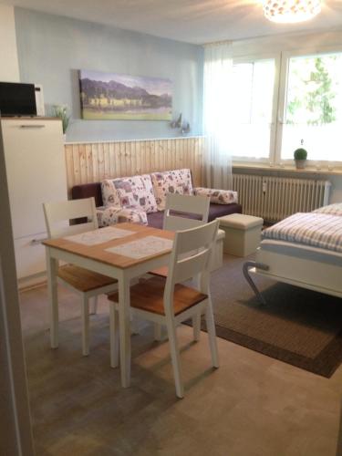 a living room with a table and chairs and a couch at Ferienwohnung mit Charme I in Todtmoos