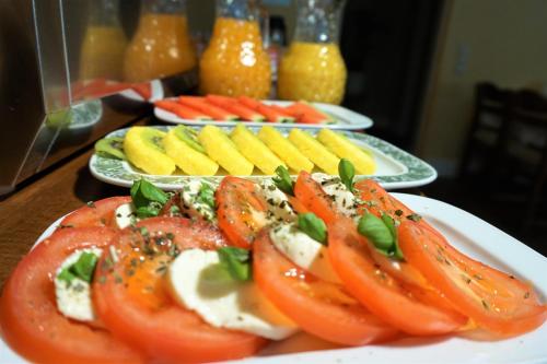 a plate of tomatoes and other food on a table at Hotel Holsteinische Schweiz am Dieksee in Malente