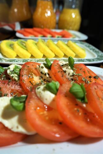 a plate of food with tomatoes and other foods at Hotel Holsteinische Schweiz am Dieksee in Malente