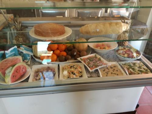 a display case filled with different types of food at Hotel Residence Villa San Giovanni in Portoferraio
