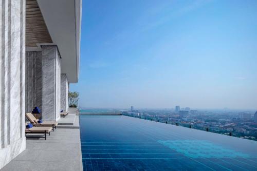 a swimming pool on the roof of a building with a view at 137 Pillars Residences Bangkok in Bangkok