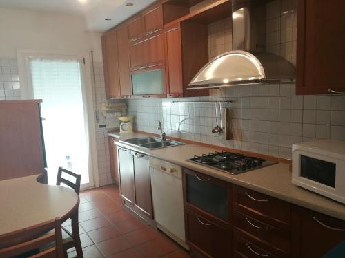 a kitchen with a sink and a stove top oven at Grado Exclusive Apartment in Grado