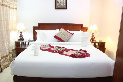 Tempat tidur dalam kamar di Zimbo Golden Hotel