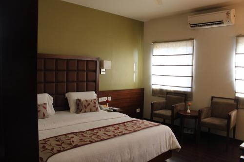 Tempat tidur dalam kamar di Hotel Stay Inn