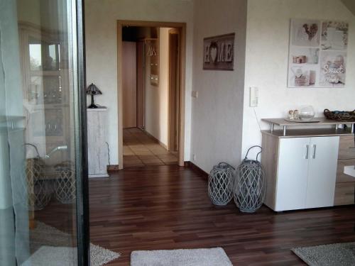 a living room with wooden floors and a glass door at Komfort_Ferienwohnung in Geldern