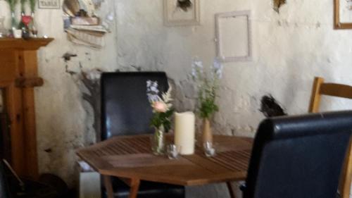 a wooden table with flowers and candles on it at Low Gingerfield Farm B&B in Richmond