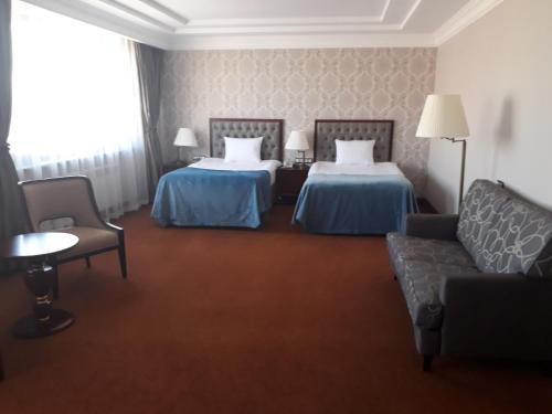 Ένα ή περισσότερα κρεβάτια σε δωμάτιο στο Sultan Plaza hotel