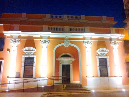 a large orange building with stairs in front of it at Domus Salentina in Leverano