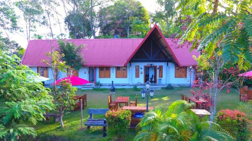 a small white house with a red roof at Orient Hotel in Bandarawela