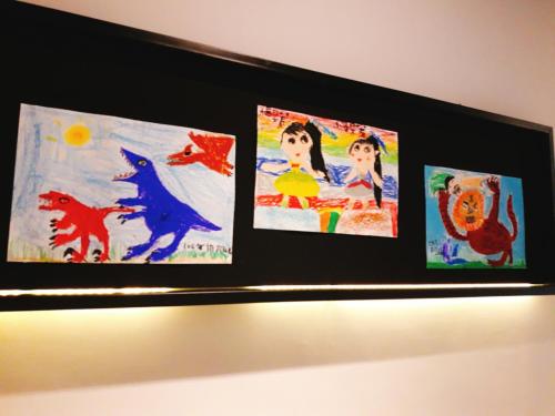 three paintings are hanging on a wall at TK Happiness 168 B&B in Donggang
