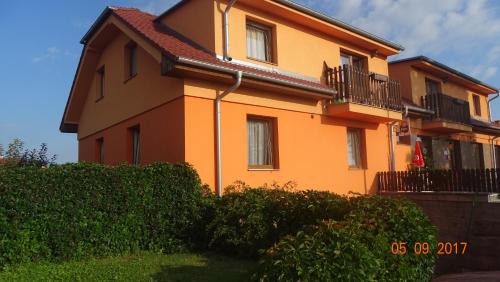 a large orange building with a balcony at Penzion Relax Martina in České Budějovice
