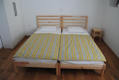 a bedroom with a bed with a wooden headboard at Apartment with Free Parking in Ljubljana
