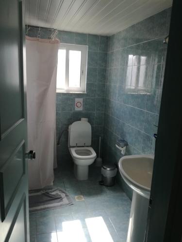 a bathroom with a toilet and a sink at Alexandra Beach in Kos Town