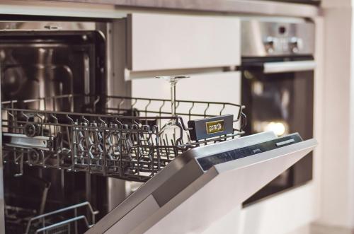 a dishwasher with a dish drying rack on it at Balokány apartman in Pécs