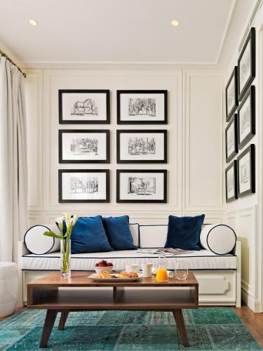 a living room with a couch and a table at H10 Duque de Loule in Lisbon