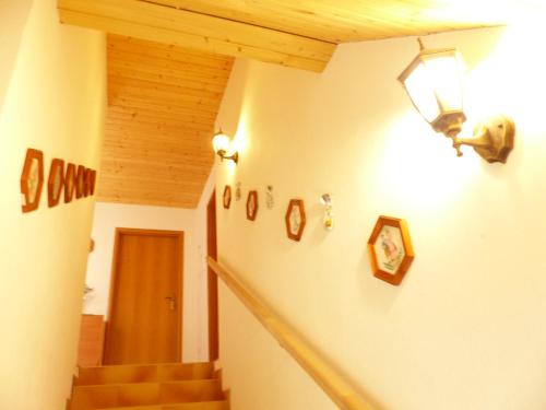 a hallway with stairs and a light on the wall at Privát Obuvník in Liptovský Ján