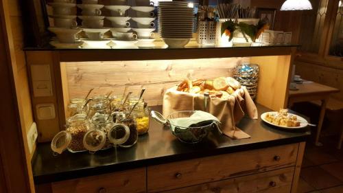 a table with bread and other food on it at Hotel Daimerwirt in Moosinning