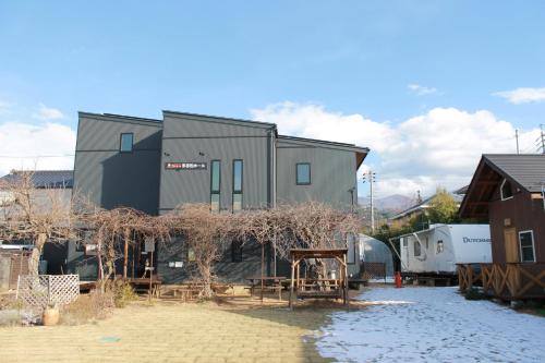 a large building with a lot of houses at Tomareru Himitsukichi L-Base in Matsumoto