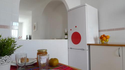a kitchen with a refrigerator and a table with fruit at Lagunilla Rural in Fuente de Piedra