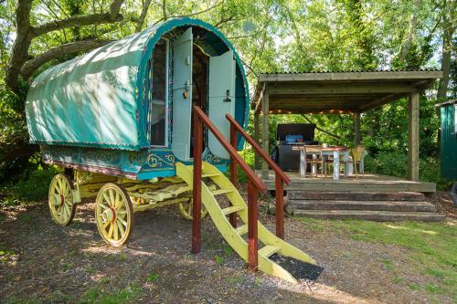 a blue and yellow train car parked in a yard at Widbrook Barns in Bradford on Avon