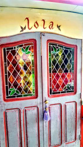 a door with stained glass windows on it at La Roulotte De Lola - Chambre d'hôtes in La Celle