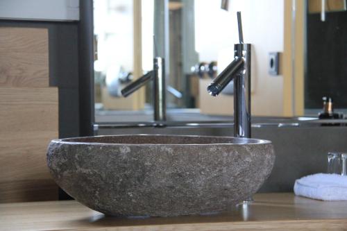 a sink with two faucets in a bathroom at Nägler´s Fine Lounge Hotel in Oestrich-Winkel