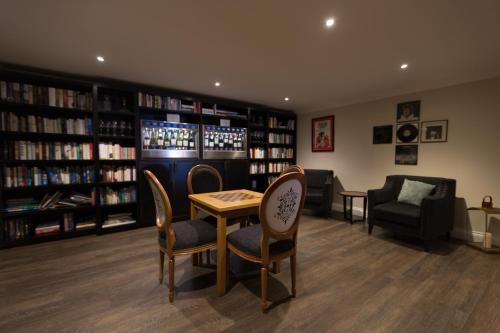 a library with a table and chairs and bookshelves at Karma St. Martin's in St Martins