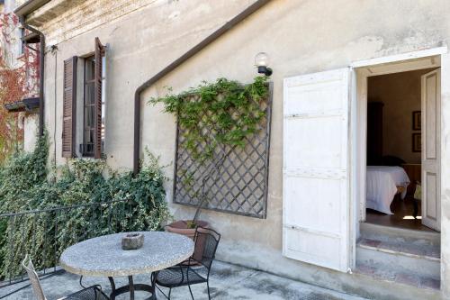 a patio with a table and chairs next to a building at Hotel Locanda Dei Mai Intees in Azzate