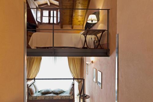 a room with a bunk bed with a window at Hotel Locanda Dei Mai Intees in Azzate