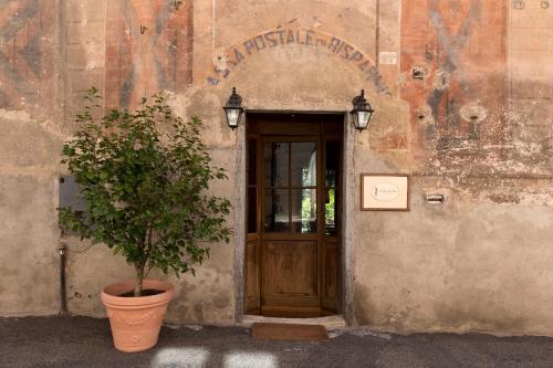 a plant in a pot in front of a door at Hotel Locanda Dei Mai Intees in Azzate