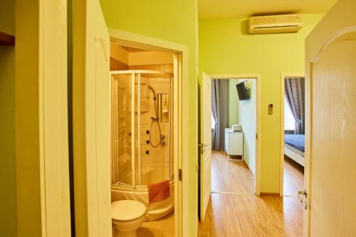 a bathroom with a shower and a toilet at Galereya in Saint Petersburg