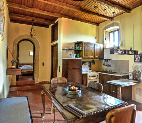 a kitchen with a table with a bowl of fruit on it at Elia House in Megála Khoráfia