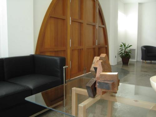 a living room with a couch and a glass table at Hotel El Patiaz de la Reina Rana in Tauste
