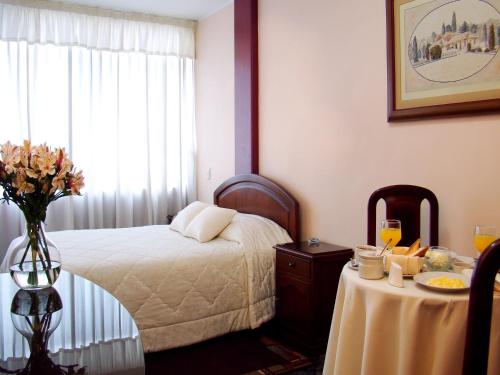 A bed or beds in a room at Hotel Torre Norte