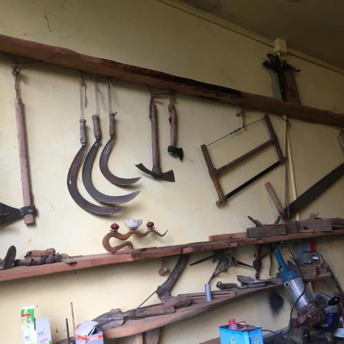 a bunch of tools hanging on a wall at Villa Baronzola in Montevarchi