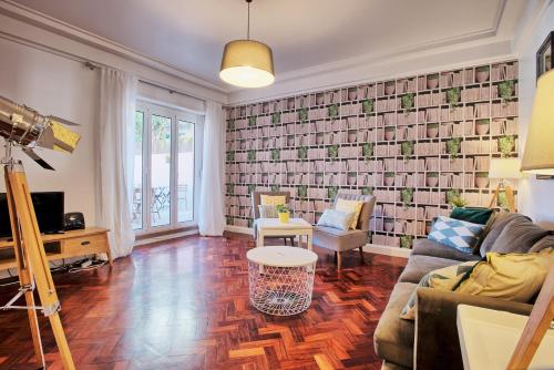 a living room with a couch and a table at Liverpool Terrace in Lisbon