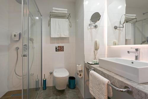 a bathroom with a sink and a toilet and a shower at Floria Beach Hotel in Alanya