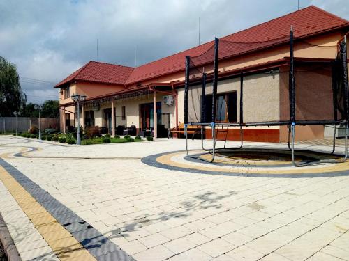 a building with a basketball hoop in front of it at Hotel Ashad in Svalyava
