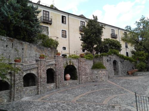 an external view of a building with a stone wall at Villa San Domenico in Morano Calabro
