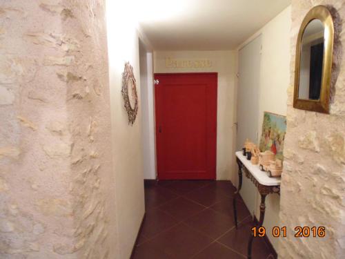a red door in a hallway with a red floor at Gite Le Clos Constance in Charrais
