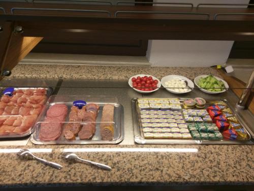 a counter with different types of meats and other foods at Gasthaus Pension Rezatgrund in Windsbach