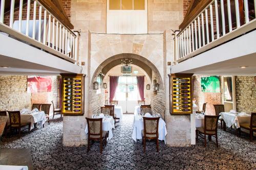 a restaurant with tables and chairs in a room at Normanton Park Hotel, Sure Hotel Collection by Best Western in Oakham