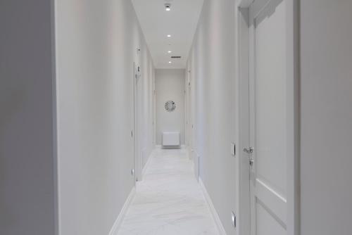 a white hallway with white walls and white floors at Altavilla Boutique Hotel in Catanzaro