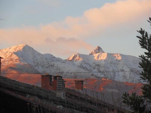 a view of snow covered mountains in the distance at B&B Cascina Marie in Bricherasio