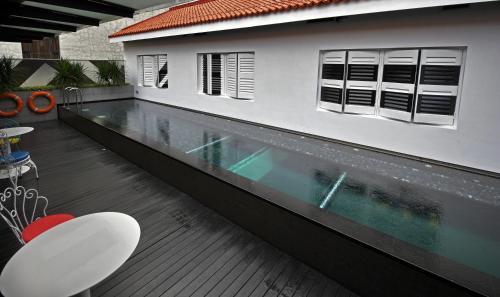 a swimming pool in the middle of a house at Hi Hotel in Singapore