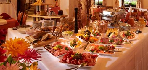 a table topped with lots of different types of food at Hotel Bergschlößchen in Simmern