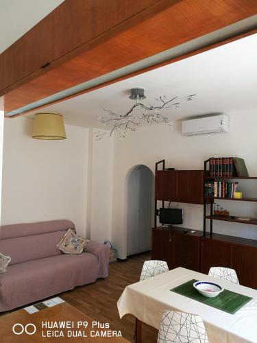a living room with a couch and a table at Costaguta Apartment in Rapallo